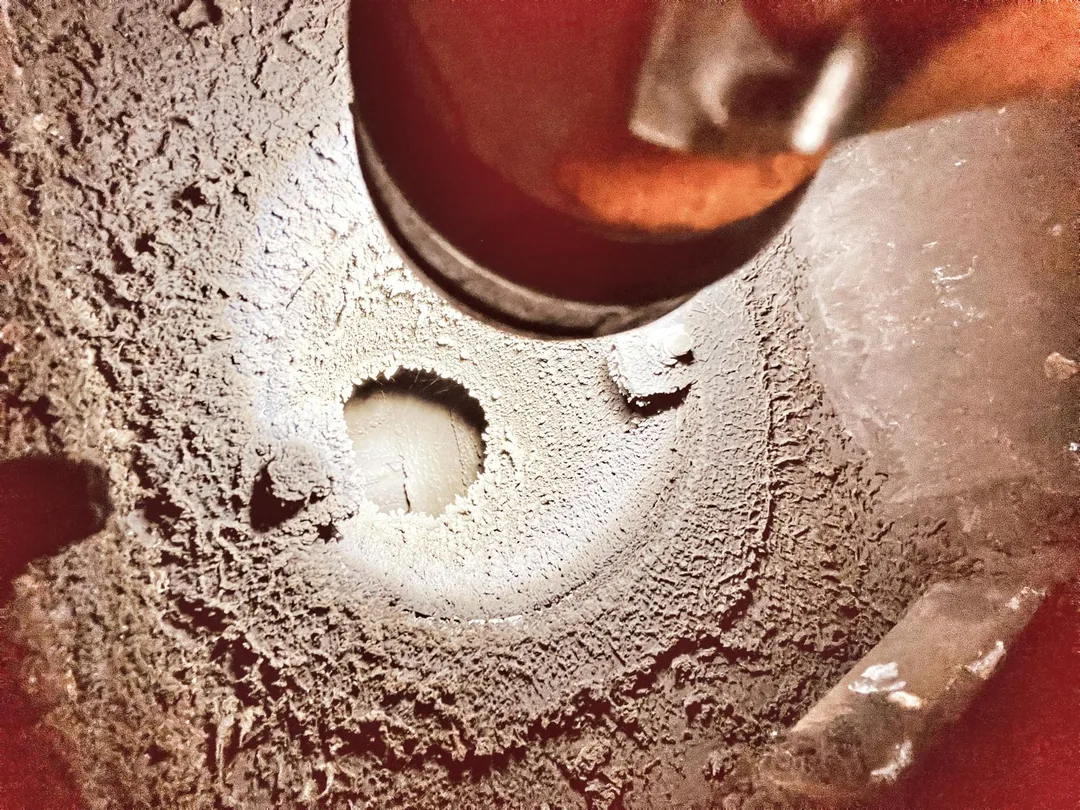 Heavy creosote and glazed tar buildup inside a chimney flue